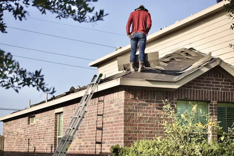 Professional roofer working on a residential roof in Elk Plain
